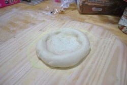 Forming Dough ball Pushing down on the center and then work your way out and then leave a 1 inch edge that will form the ball.
