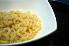 Add the macaroni to the bowl with the cheese sauce