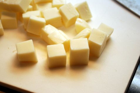Slice the cheese into equal portions Slice the cheese into equal portions