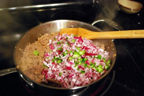 Add the onions and peppers to the mixture Add the onions and peppers to the mixture